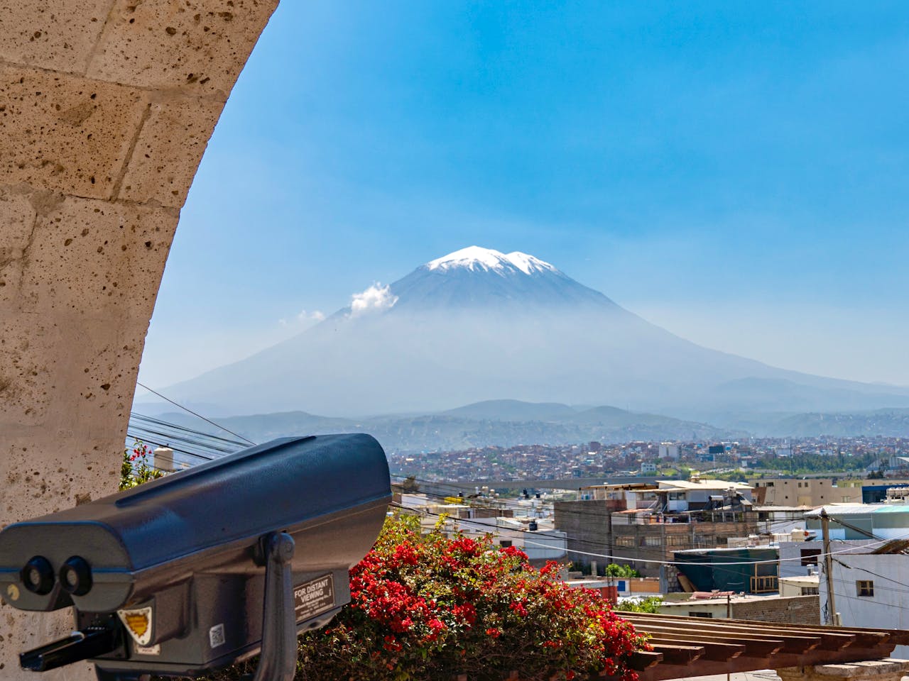 Beautiful view of Misti Volcano with cityscape of Arequipa, Peru under a clear blue sky.
